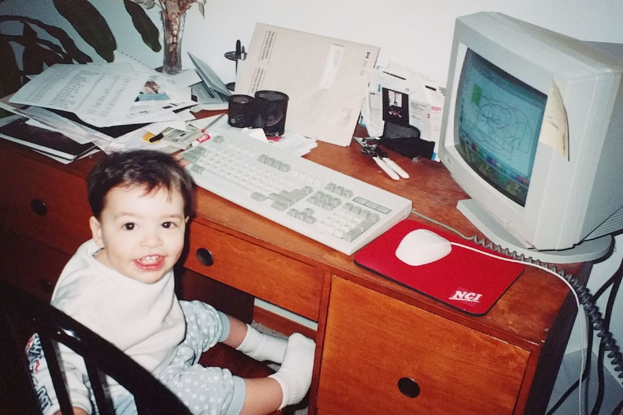 Toddler version of myself playing on a Windows 95 PC.